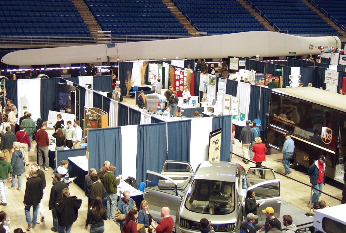 Attendees and exhibitors at a Clean Energy Expos. GE brought the wind  turbine seen in the background all the way from Texas for the event. 