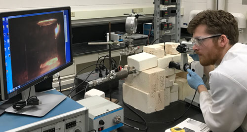 Graduate student Tim Duffy is aligning electrodes before taking electrophoretic measurements.