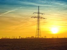 Photo of electric wires against a sunset.