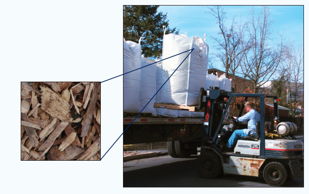 Brad Maben, senior research technician, unloads a delivery of wood chips at the EMS Energy Institute.