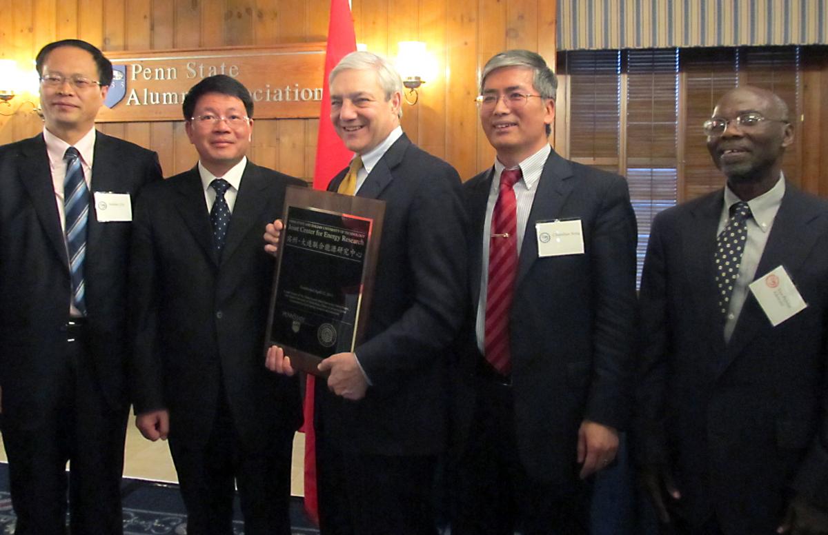 From left to right: JCER co-director from DUT Jieshan Qiu, DUT Presidient Jinping Ou, Penn State President Graham Spanier, JCER co-director from Penn State Chunshan Song, and Penn State Vice Provost Michael Adewumi with the plaque commemorating the new Center.  