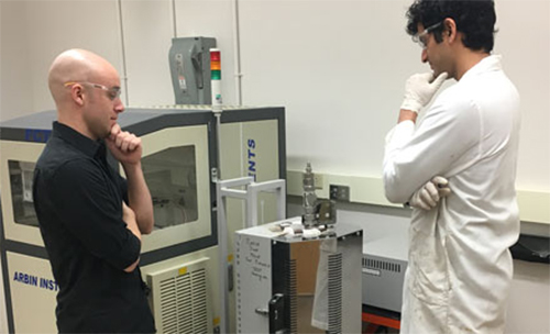 Graduate student Balaji Raman and Dr. Derek Hall are deciding on how best to position a Solid Oxide Fuel Cell test system.