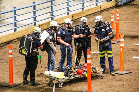 The Penn State Mount Nittany Mine Rescue Team works it way through the mock mine hazards.