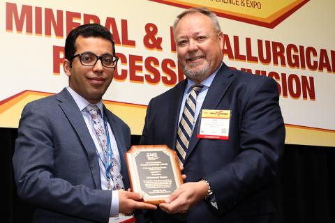 In an event held in February 2020, Mohammad Rezaee, left, received the Outstanding Young Engineer Award from James Metsa, chair 