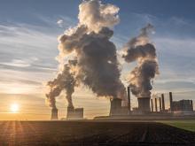 Power plants with emissions at sunset.
