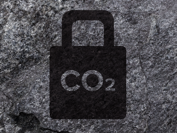 Dark gray padlock shape with "CO₂" in the middle, against a gray rocky background.